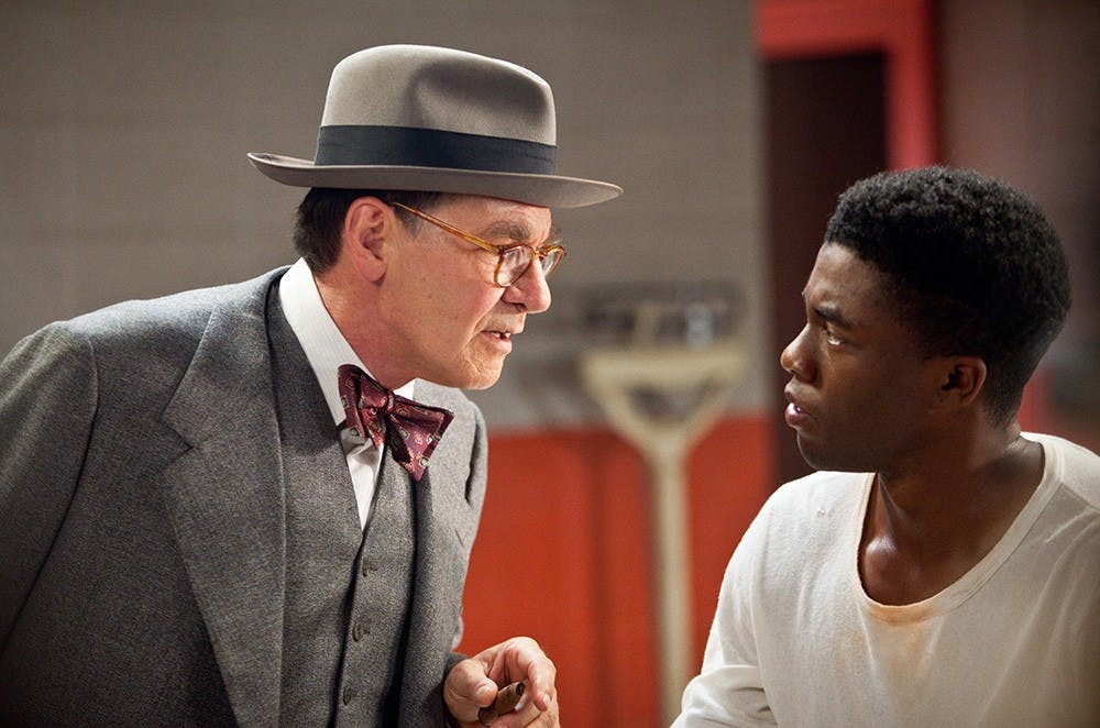 Harrison Ford, left, as Branch Rickey and Chadwick Boseman (right) as Jackie Robinson are seen in Warner Bros. Pictures and Legendary Pictures drama &quot;42,&quot; a Warner Bros. Pictures release. (D. Stevens/Warner Bros/MCT)