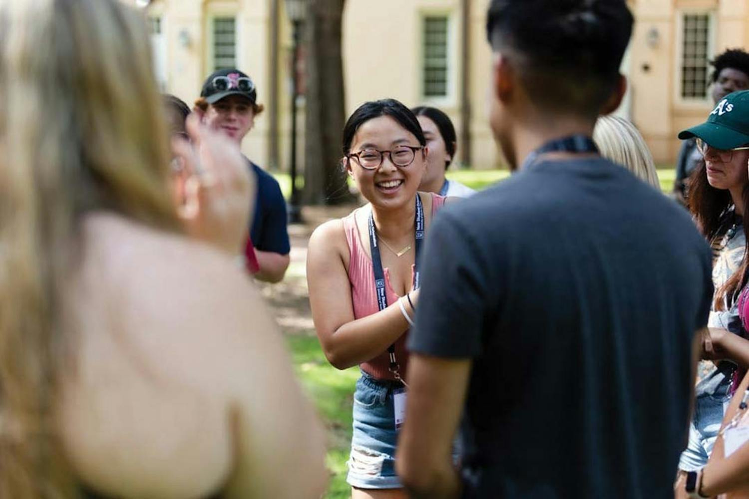 A first-year student laughs while playing a game of rock paper scissors on The Horseshoe during an orientation session on July 20, 2022. Before starting their first semester at 鶹С򽴫ý, first-year students attend a two-day program to introduce them to campus and college life. 