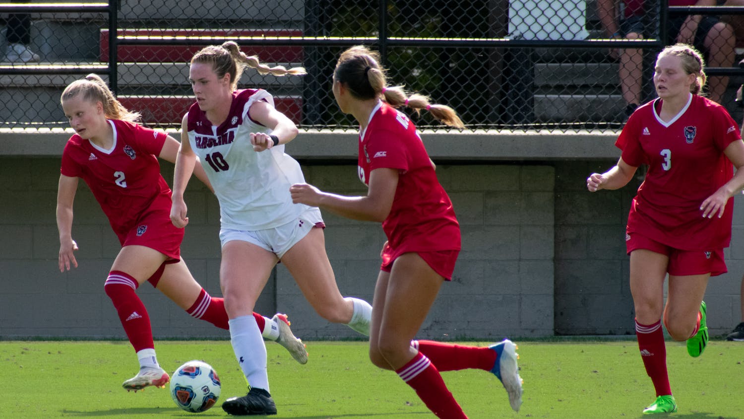 FILE—Junior forward, Catherine Barry, runs the ball past NC State soccer players. The Gamecocks tied with the Wolfpack, 0-0, on Sept. 11, 2022. &nbsp;