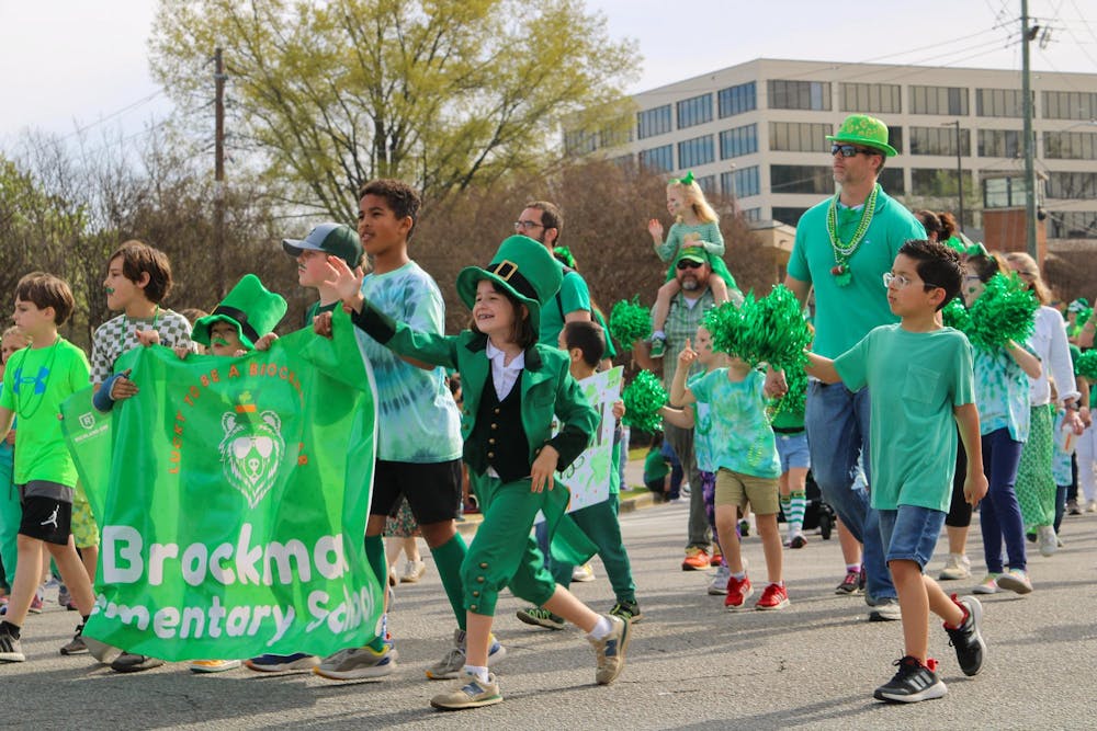 <p>FILE — Children greet the crowd as they walk in the St. Pat’s Parade on March 16, 2024. The parade is part of an annual all-day festival full of St. Patrick’s Day festivities in Five Points.</p>