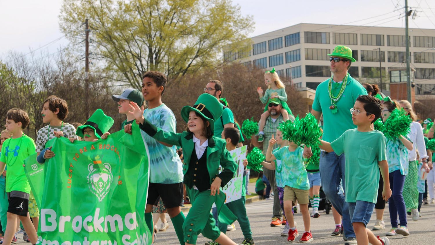 FILE — Children greet the crowd as they walk in the St. Pat’s Parade on March 16, 2024. The parade is part of an annual all-day festival full of St. Patrick’s Day festivities in Five Points.