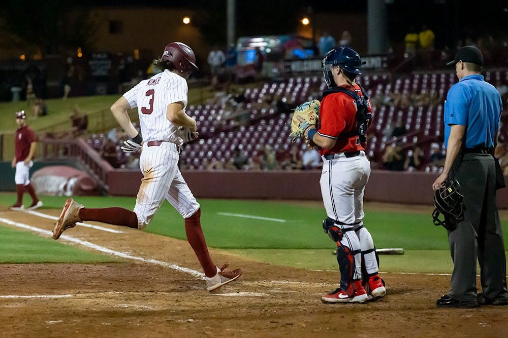 South Carolina Junior infielder Brayden Wimmer (on left) runs into home base during the series-opening game vs. Ole Miss on April 14th, 2022. Ole Miss bested South Carolina 9-1. 