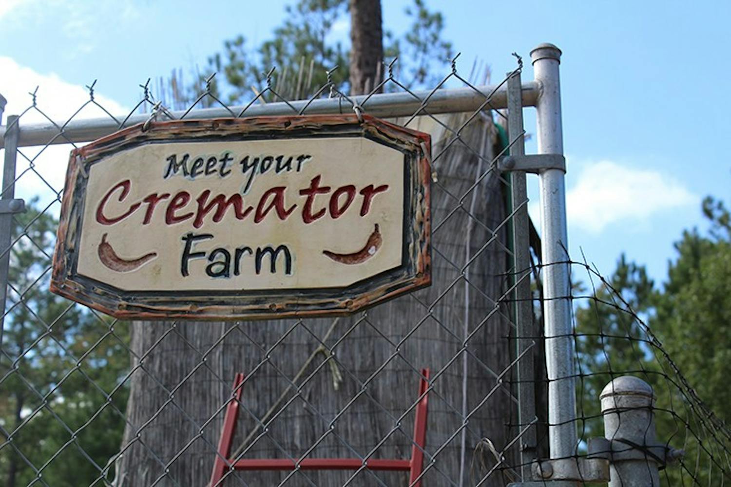The sign for Meet Your Cremator Farm sits on the front gate. The farm grows peppers that are used to make some of its award-winning hot sauces.