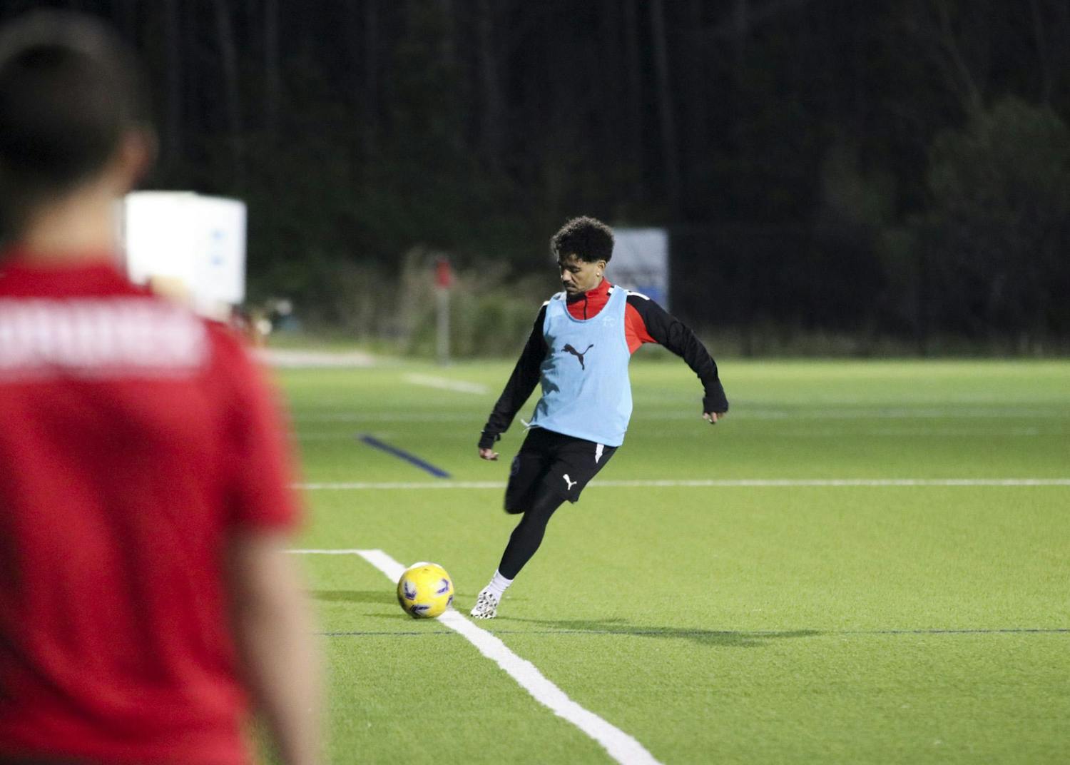 Midfielder Ronaldo Fortune kicks the ball toward his teammate during South Carolina United Heat's warmups on March 29, 2024, at the Southeastern Freight Lines Soccer Canter. SCU Heat is a member of the United Premier Soccer League, the largest pro-development league in the US, with nearly 400 teams nationally.