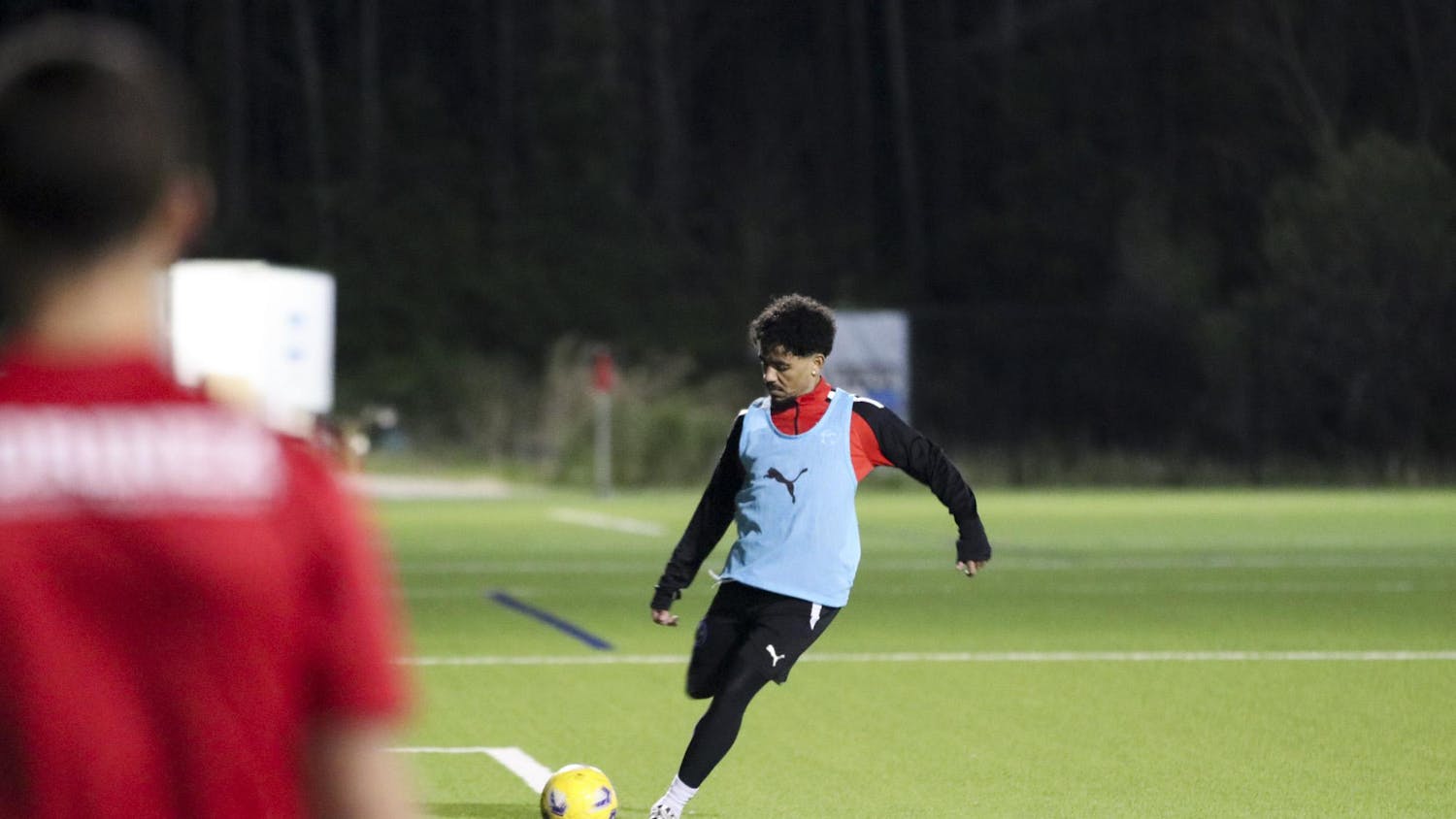 Midfielder Ronaldo Fortune kicks the ball toward his teammate during South Carolina United Heat's warmups on March 29, 2024, at the Southeastern Freight Lines Soccer Canter. SCU Heat is a member of the United Premier Soccer League, the largest pro-development league in the US, with nearly 400 teams nationally.