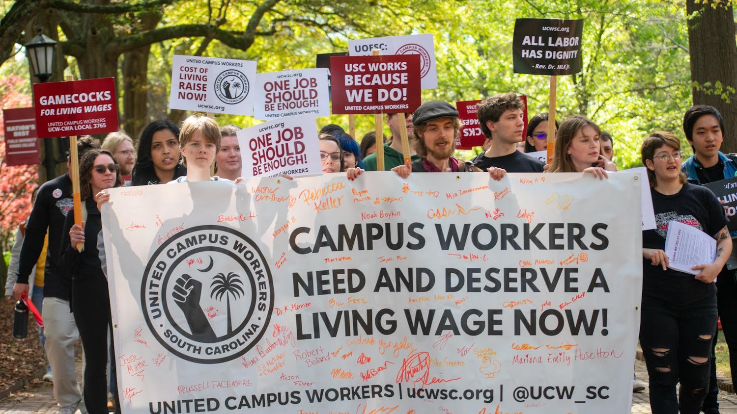 Members and supporters of the United Campus Workers march toward the Osborne Administrative Building following a rally outside of USC President Michael Amiridis' home on March 28, 2024. The union delivered a petition created last August to Stacy Fritz, the chief of staff at the University of South Carolina.