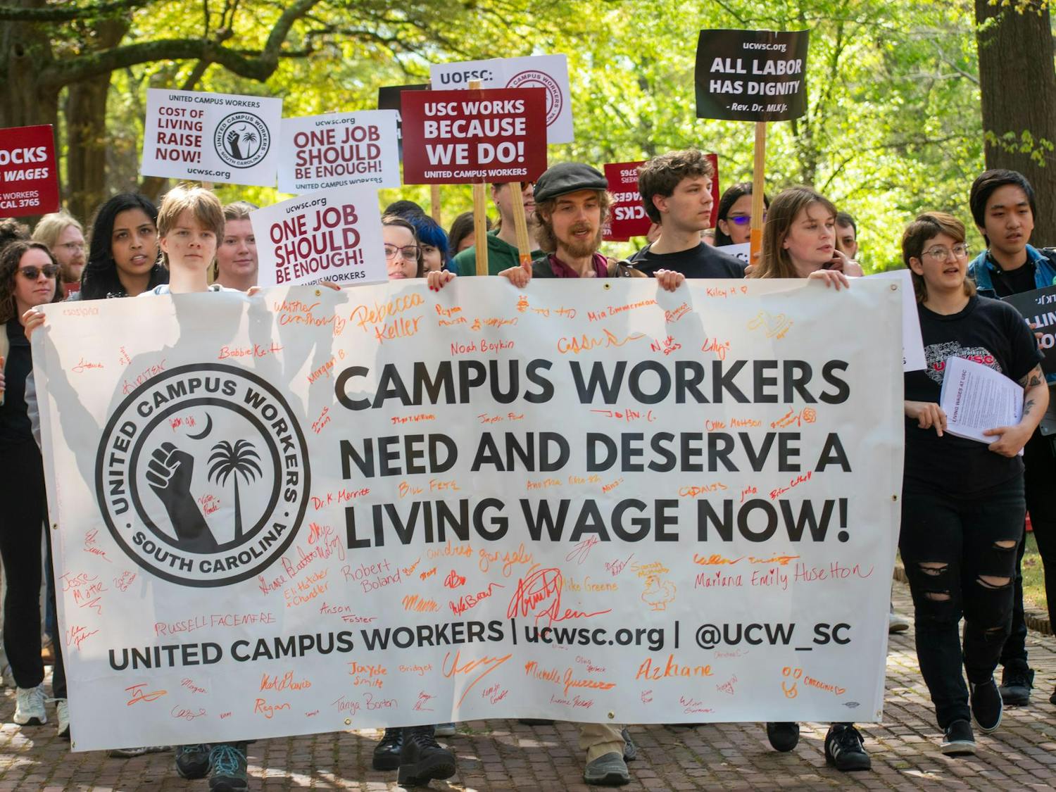 Members and supporters of the United Campus Workers march toward the Osborne Administrative Building following a rally outside of USC President Michael Amiridis' home on March 28, 2024. The union delivered a petition created last August to Stacy Fritz, the chief of staff at the University of South Carolina.