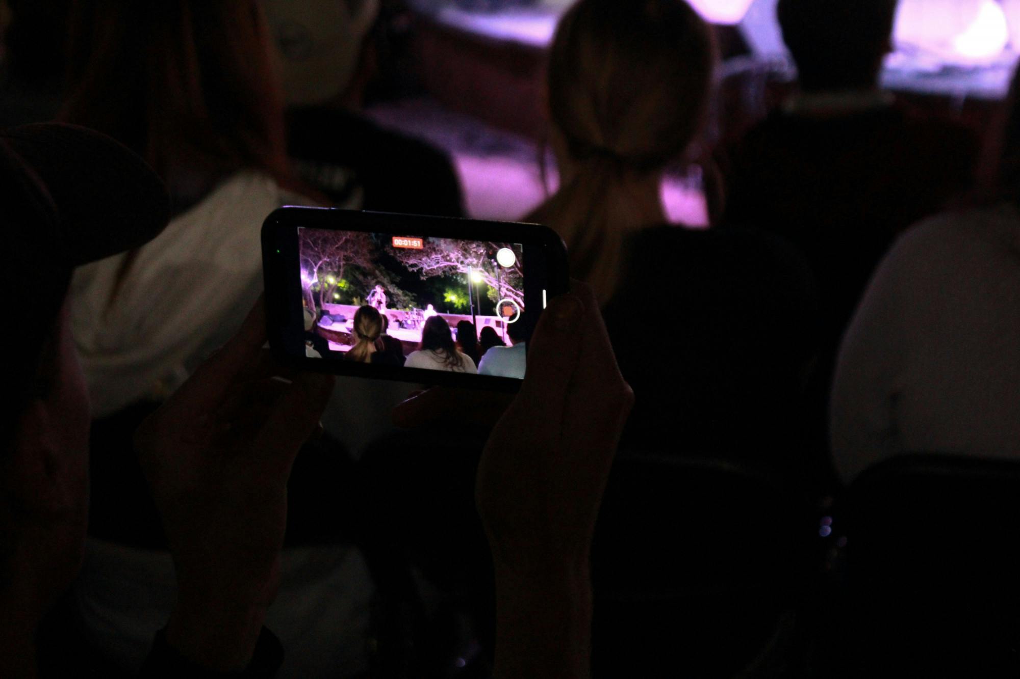 A closeup of a crowd member's phone as they record a Battle of the Bands performance on Oct. 5, 2022. The competition brought acapella, folk, rap and rock music to the Russel House Patio in a variety of performances.