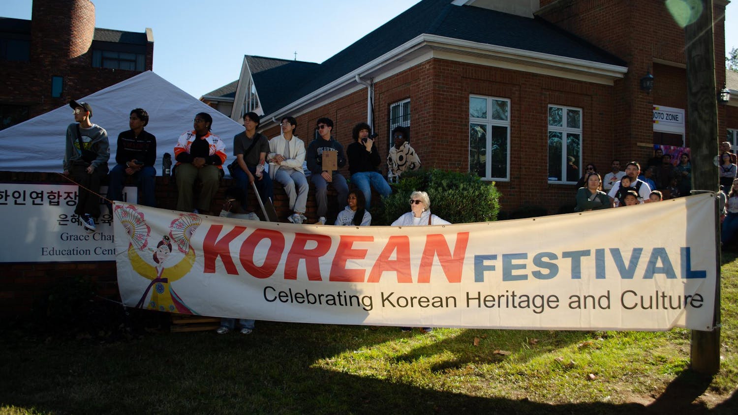 People watch performances at the Korean Festival at 1412 Richland St., Columbia, South Carolina on Nov. 1, 2025. They are in front of the Korean Community Presbyterian Church, who hosted the event.