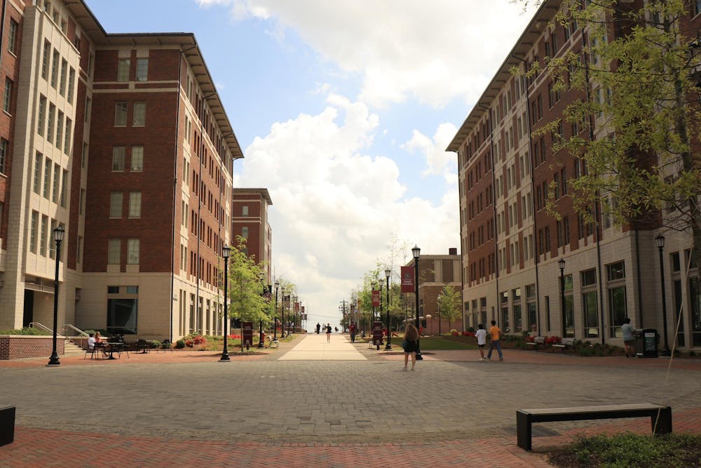 <p>FILE — A picture of students walking around in Campus Village on Apr. 4, 2025. The four buildings serve as a residential home for 1,800 students.</p>