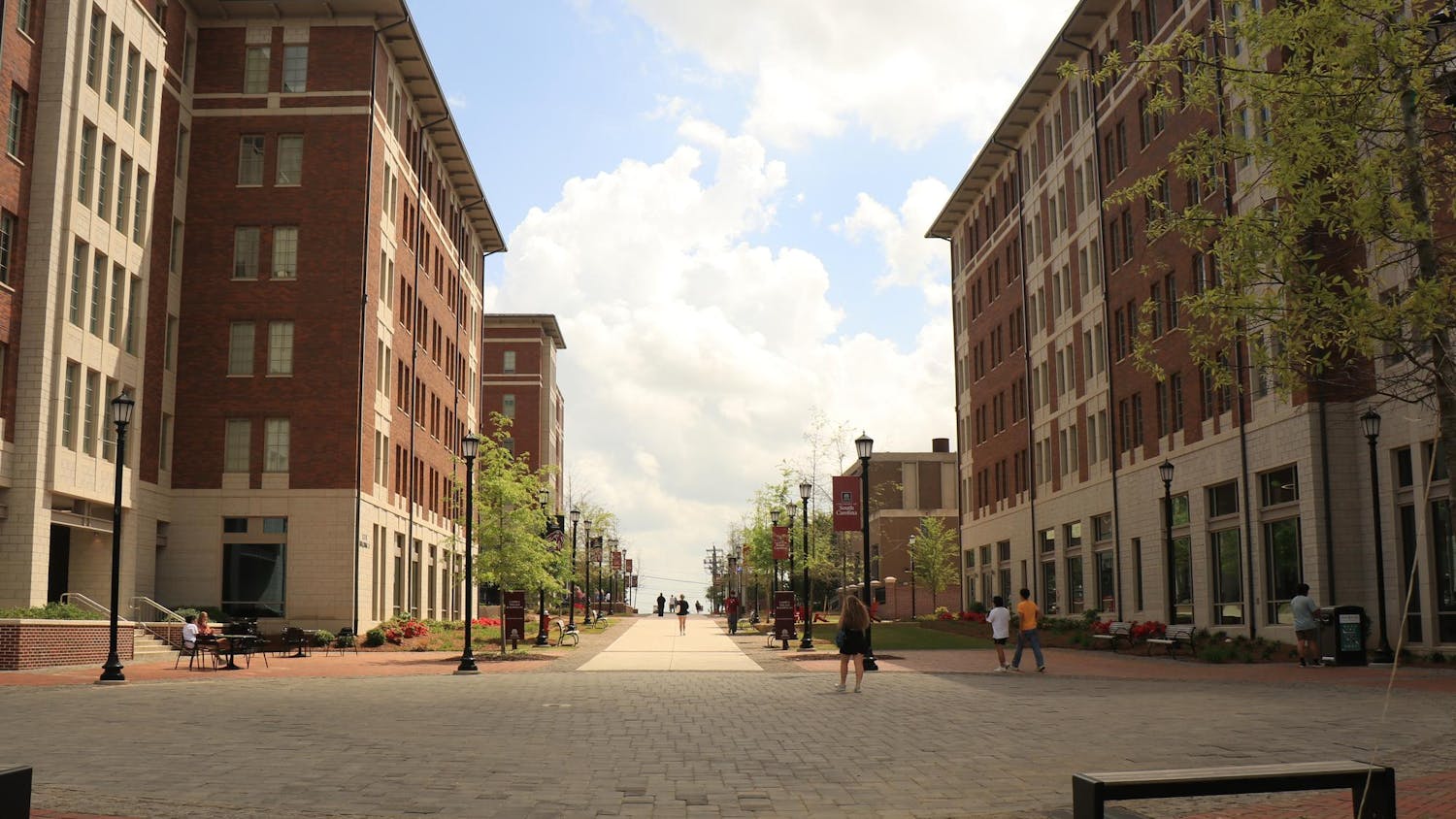 FILE — A picture of students walking around in Campus Village on Apr. 4, 2025. The four buildings serve as a residential home for 1,800 students.