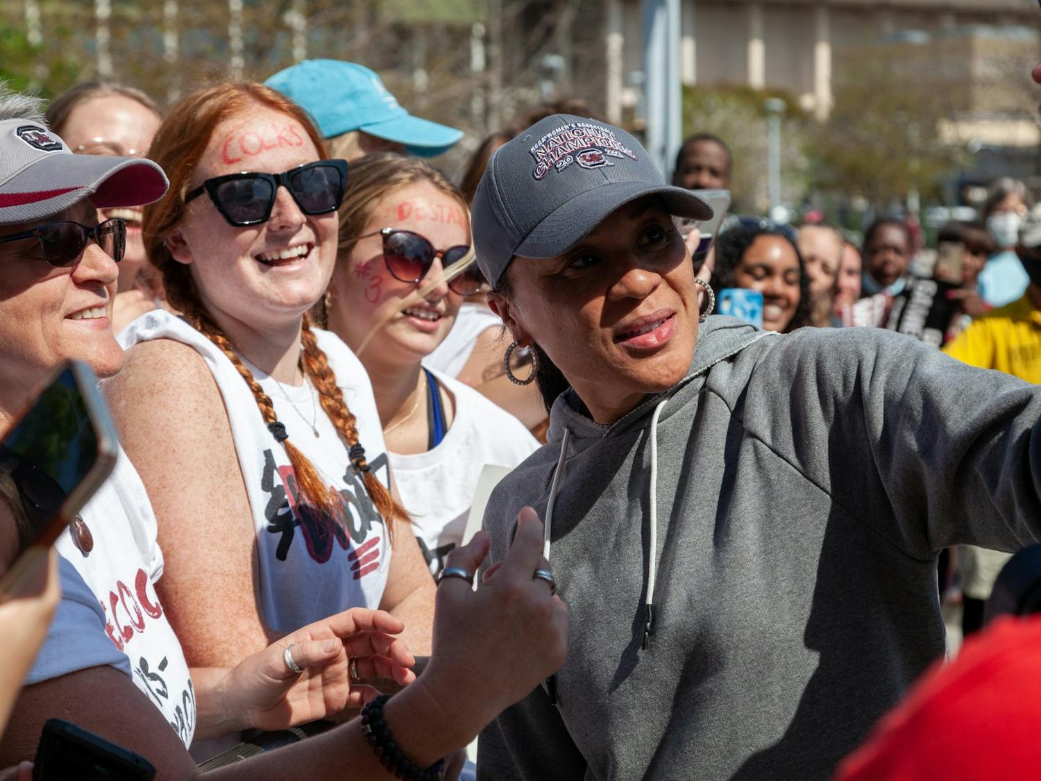 South Carolina women's basketball head coach Dawn Staley takes selfies with fans at Colonial Life Arena on April 4, 2022. Fans were excited to welcome the team back to Columbia.&nbsp;
