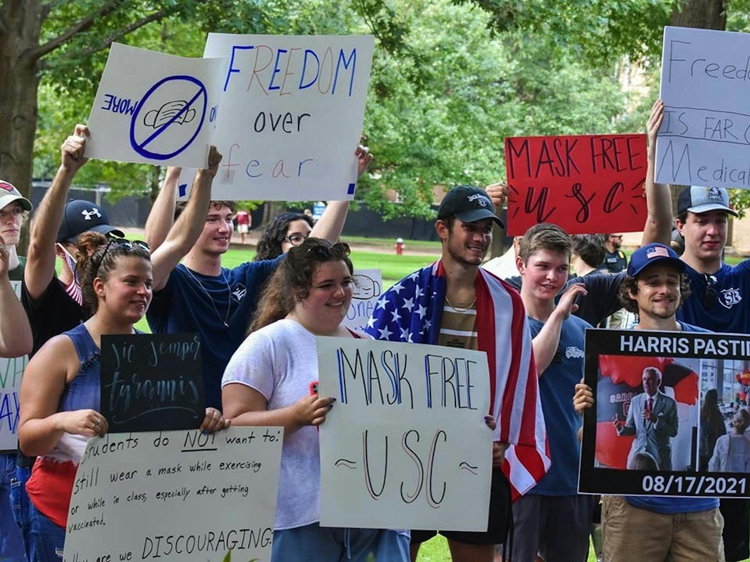 Members of the USC chapter of Turning Point USA pose with their signs on the Horseshoe after their protest. Turning Point USA’s protest was in response to the university's mask mandate and included Student Government senators John Hladun and Matt Harris.