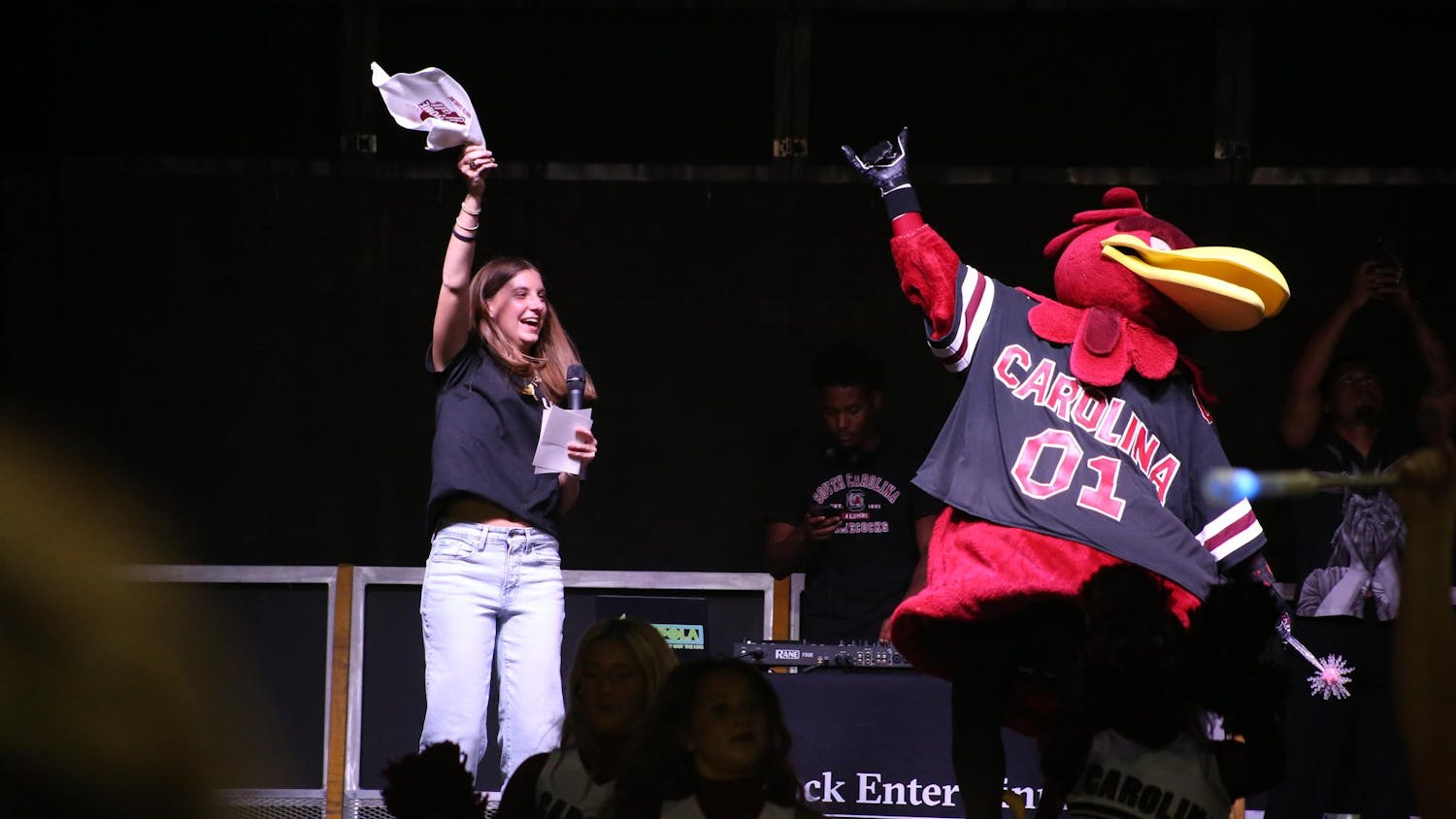 A Tiger Burn host and Cocky jump on stage during the playing of “SandStorm” during Tiger Burn at Blatt Field on Nov. 19, 2025. The annual event is part of the rivalry week of events leading up to a football game against Clemson.
