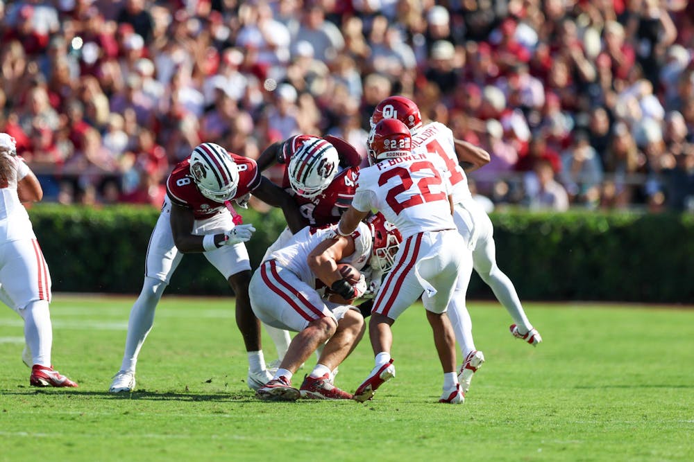 <p>FILE — An Oklahoma defender carries the football after catching an interception from freshman quarterback Cutter Woods on Oct. 18, 2025, at Williams-Brice Stadium. The Gamecocks have thrown nine interceptions on the season.</p>