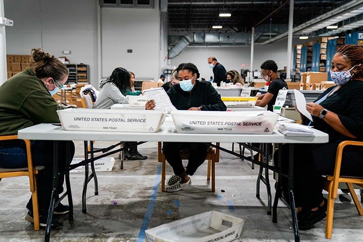 Election workers validate ballots at the Gwinnett County Elections Office on Friday, Nov. 6, 2020 in Lawrenceville, GA.