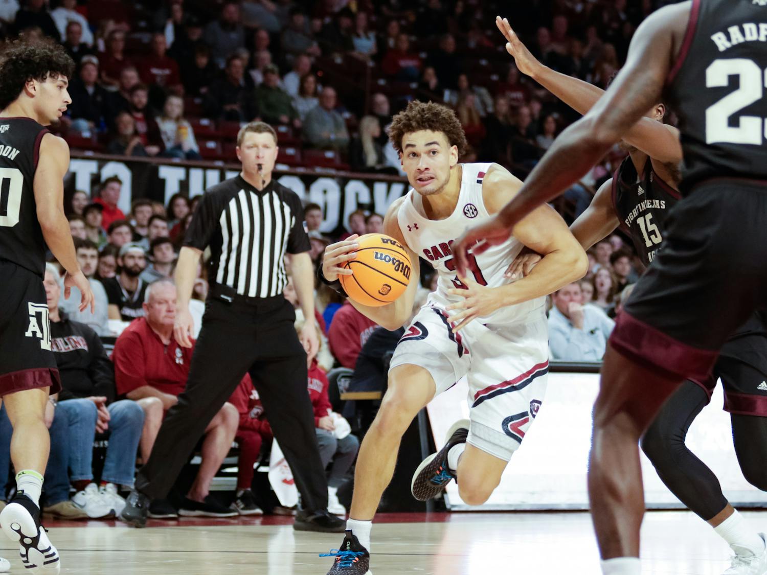 junior forward Benjamin Bosmans-Verdonk dribbles the ball around the defender from Texas A&M at Colonial Life Arena on Jan. 14, 2023. The South Carolina Gamecocks lost the game 53 to 94.