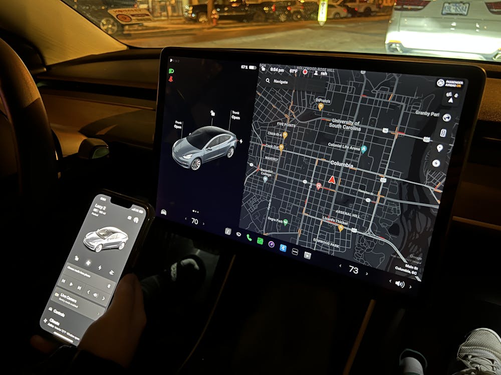 <p>Columbia resident Laura Streit uses the Tesla app in her Tesla Model 3 to find a nearby charging station on Feb. 8, 2023. A Tesla's built-in touch screen offers an easy-to-use navigation system to help drivers locate supercharger stations and other necessities.&nbsp;</p>
