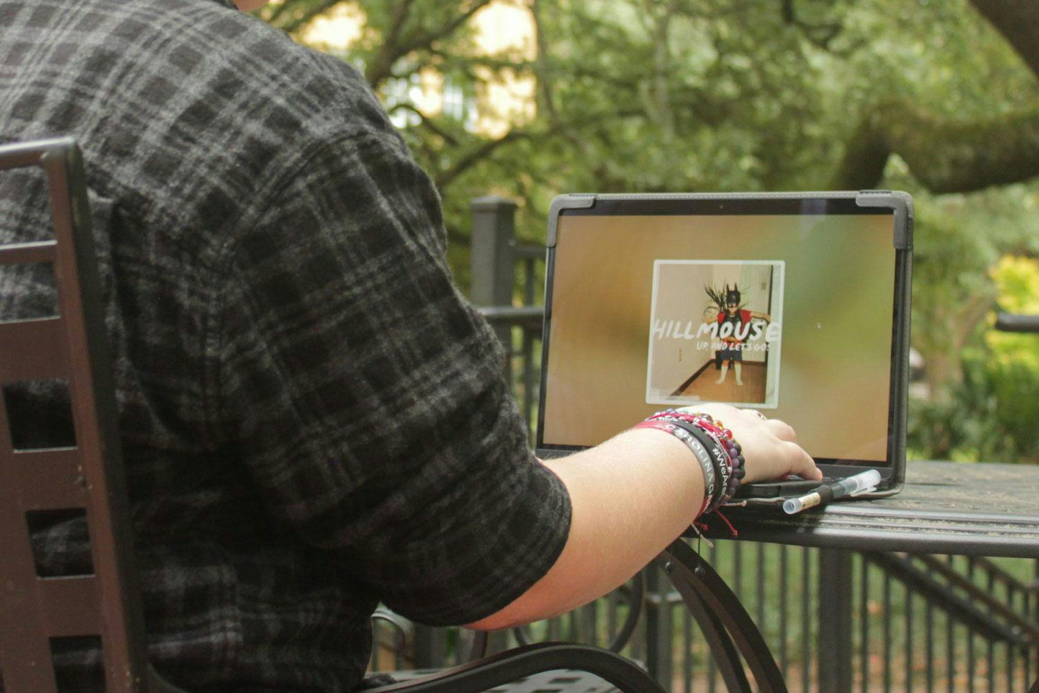 A photo illustration of a person listening to Hillmouse's new album "Up, And Let’s Go!" on a computer. "Up, And Let’s Go!” is the third album released by the Columbia, South Carolina indie rock artist.