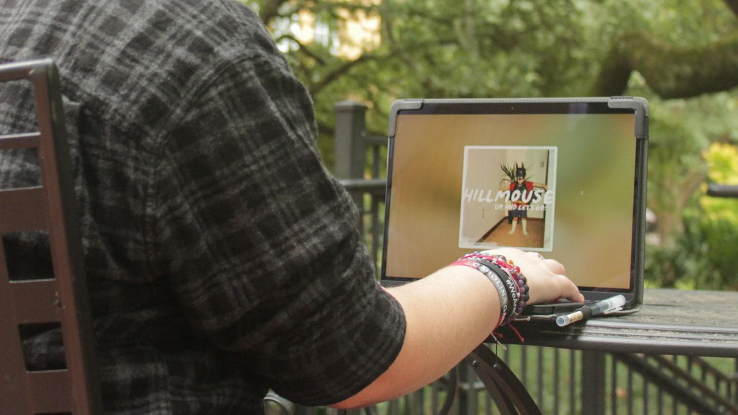 A photo illustration of a person listening to Hillmouse's new album "Up, And Let’s Go!" on a computer. "Up, And Let’s Go!” is the third album released by the Columbia, South Carolina indie rock artist.