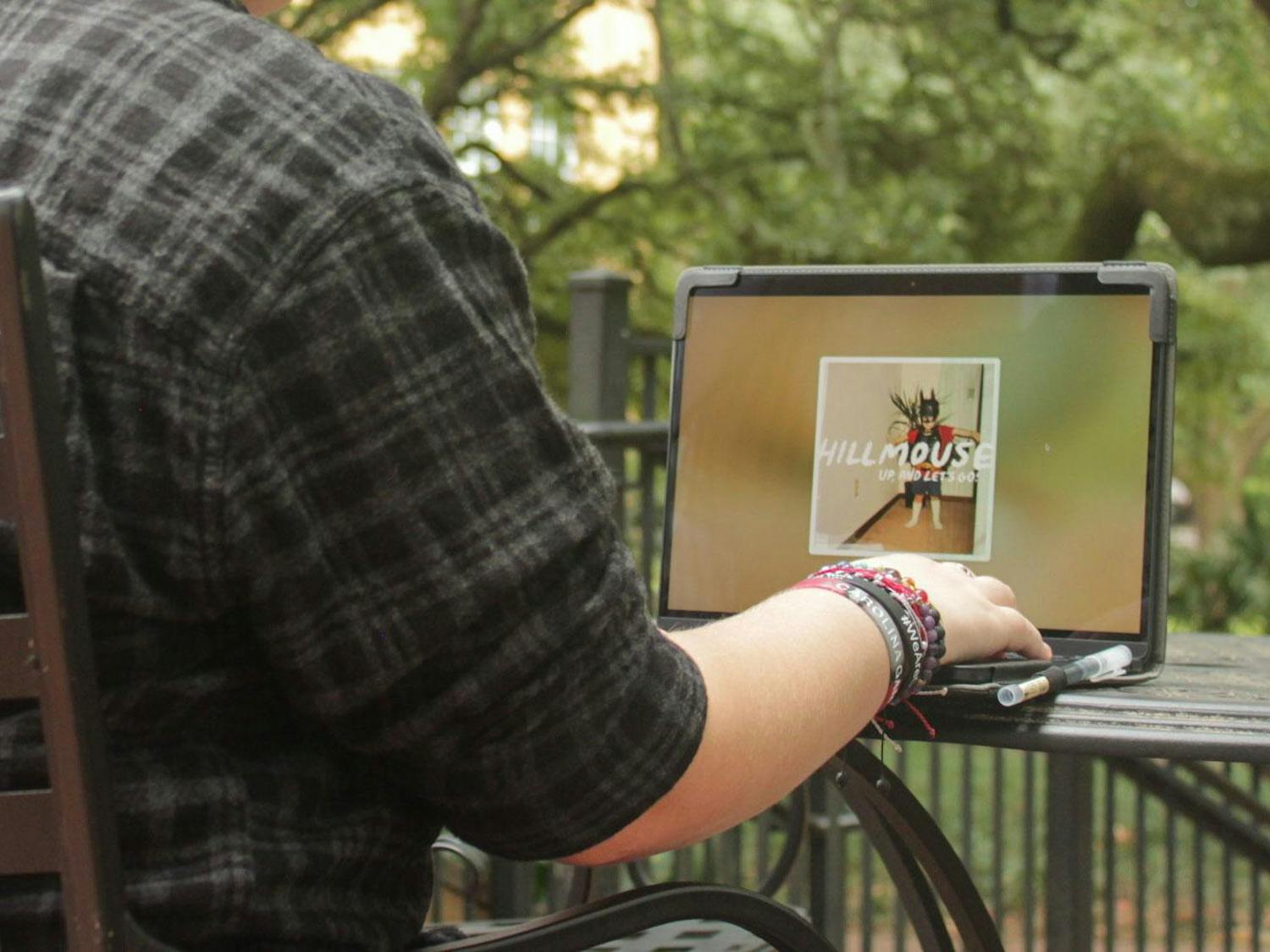 A photo illustration of a person listening to Hillmouse's new album "Up, And Let’s Go!" on a computer. "Up, And Let’s Go!” is the third album released by the Columbia, South Carolina indie rock artist.