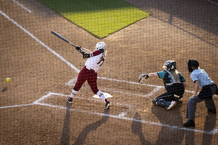 Junior infielder Kassidy Krupit swings and hits a grounder, bringing her to first base.