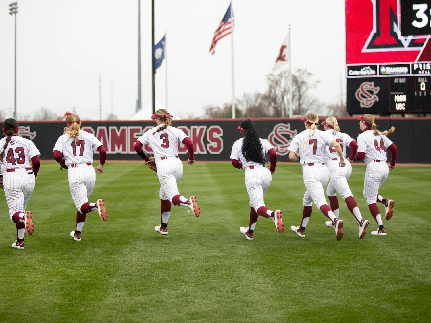Members of the University of South Carolina softball team run into the outfield to warm up for their game against Miami Ohio on Feb. 15, 2025. With the win against Miami, the Gamecocks moved to 9-0 on the season.