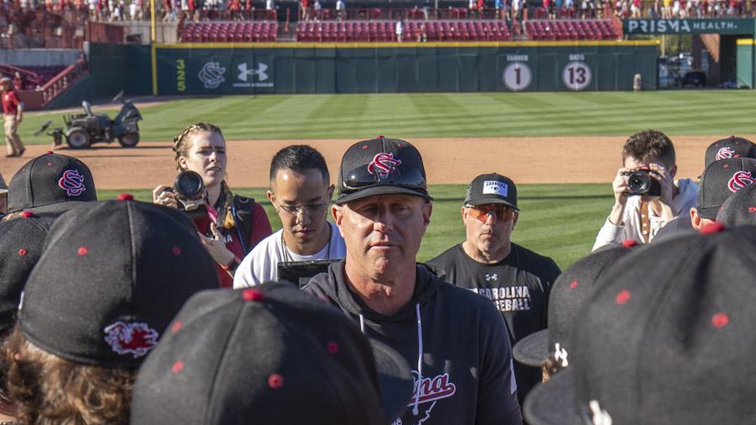 FILE — Head coach Mark Kingston debriefs the team after its win against Clemson at Founders Park on March 5, 2023. The Gamecocks beat the Tigers 7-1.
