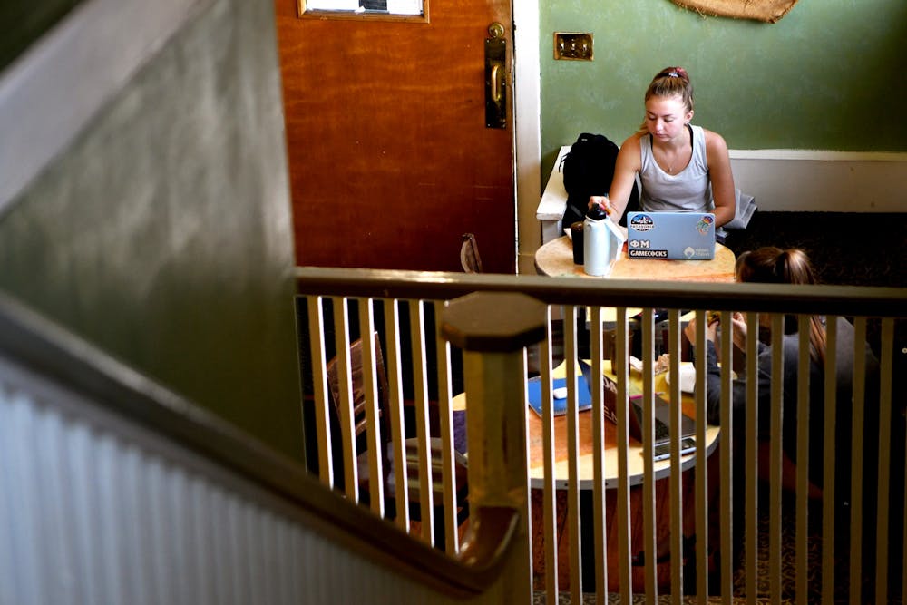 First-year undecided student Abigail Clarke eats while doing schoolwork on the first floor of Cool Beans Coffee Co.