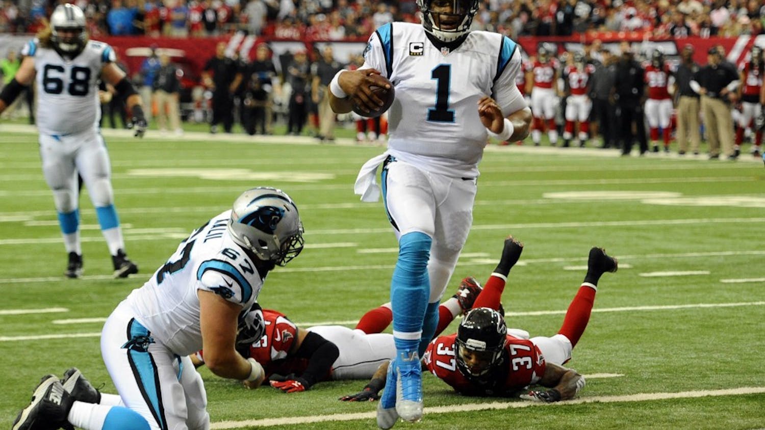 Carolina Panthers&apos; Cam Newton (1) runs into the end zone for a touchdown past Atlanta Falcons&apos; Ricardo Allen (37) during the first quarter on Sunday, Dec. 27, 2015, at Georgia Dome in Atlanta. (David T. Foster III/Charlotte Observer/TNS)