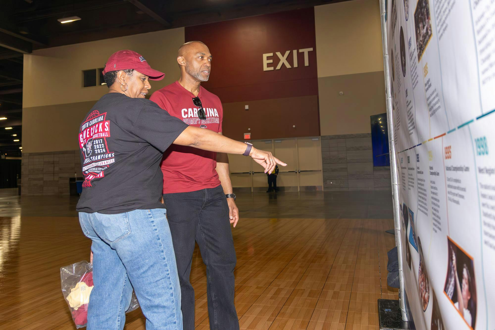 Virginia residents Nicki and Clarence Hudson look over the history of the NCAA women's basketball program on a display at Tourney Town during the Final Four on April 3, 2026. The Hudsons love Dawn Staley and the Gamecocks and are hoping the team succeeds over the UConn Huskies.