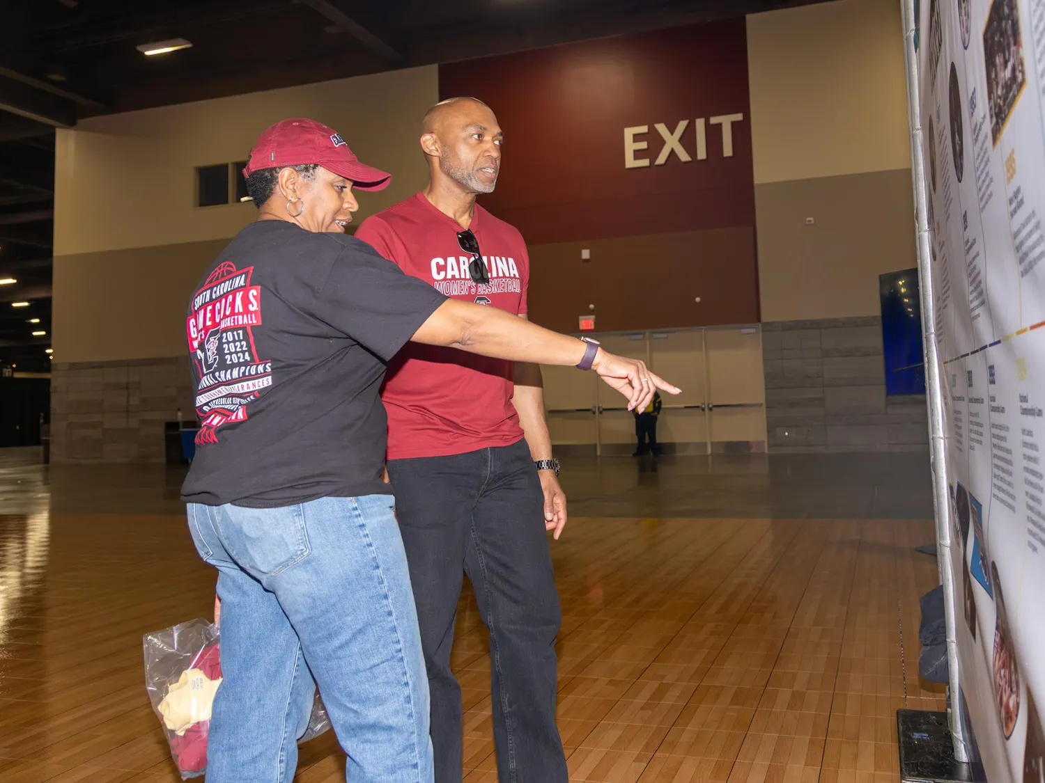 Virginia residents Nicki and Clarence Hudson look over the history of the NCAA women's basketball program on a display at Tourney Town during the Final Four on April 3, 2026. The Hudsons love Dawn Staley and the Gamecocks and are hoping the team succeeds over the UConn Huskies.
