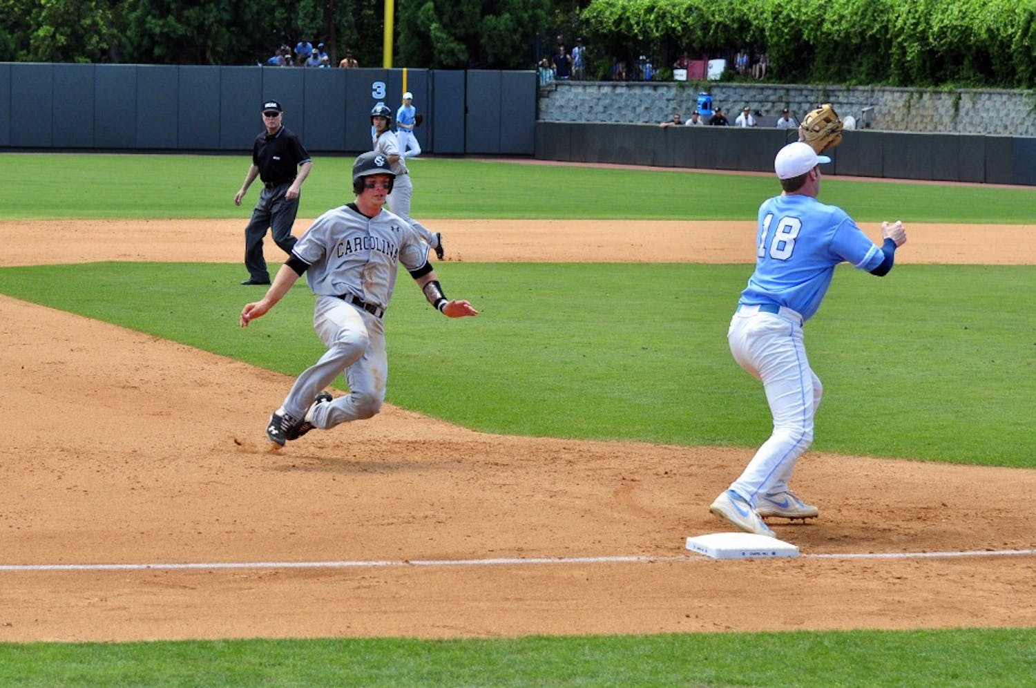Grayson Greiner gets tagged out while sliding into third base.