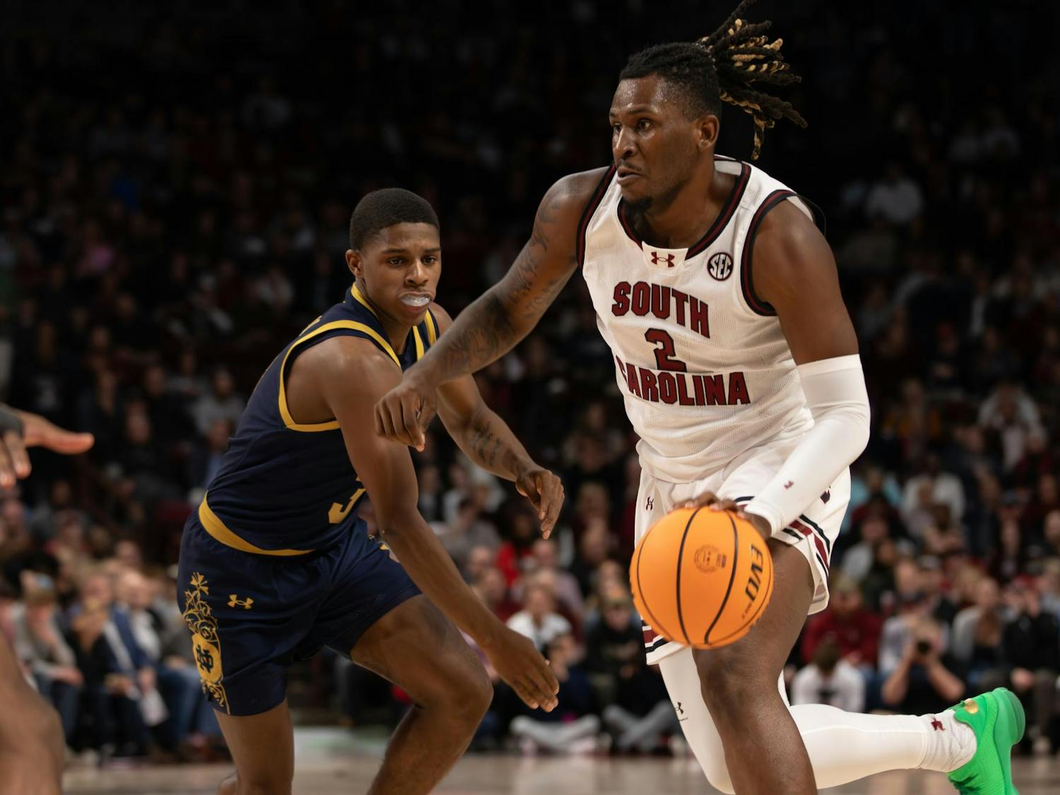 Graduate forward B.J. Mack dribbles past a Notre Dame defender towards the hoop on Nov. 28, 2023. Mack ended the game with a total of 17 points and was the Gamecocks' second leading scorer in the win over the Fighting Irish.