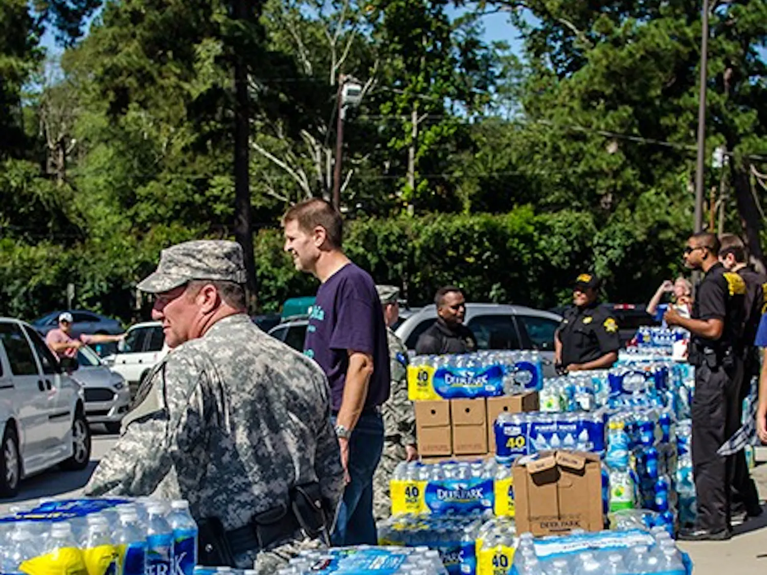Volunteers work the water supply line at AC Flora High School on Oct. 6.