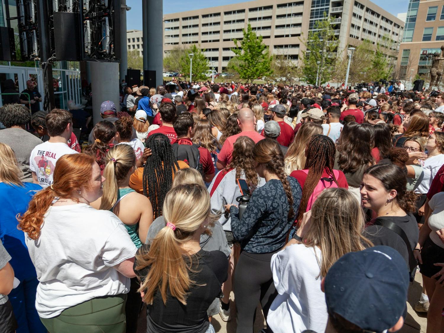 South Carolina fans prepare for the women's basketball team to arrive at Colonial Life Arena in Columbia, SC on April 4, 2022. Fans crowded around the outside arena before the team arrived.