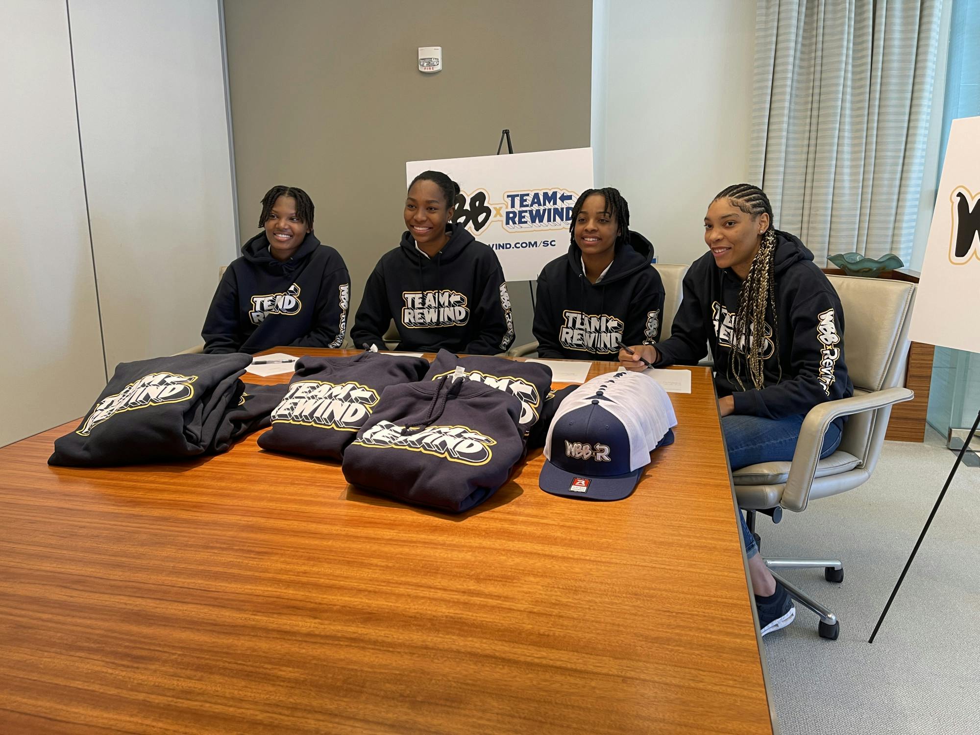 Women’s basketball players (left to right) Sania Feagin, Bree Hall, Kierra Fletcher and Victaria Saxton smile after signing their NIL deals with Rewind on Oct. 6, 2022. South Carolina women’s basketball is partnering with the Rewind program to help fight diabetes in the state of South Carolina.
