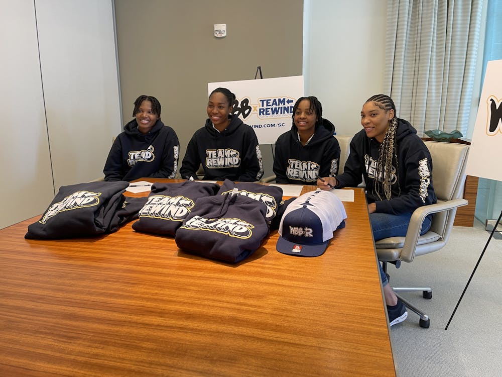 <p>Women’s basketball players (left to right) Sania Feagin, Bree Hall, Kierra Fletcher and Victaria Saxton smile after signing their NIL deals with Rewind on Oct. 6, 2022. South Carolina women’s basketball is partnering with the Rewind program to help fight diabetes in the state of South Carolina.</p>