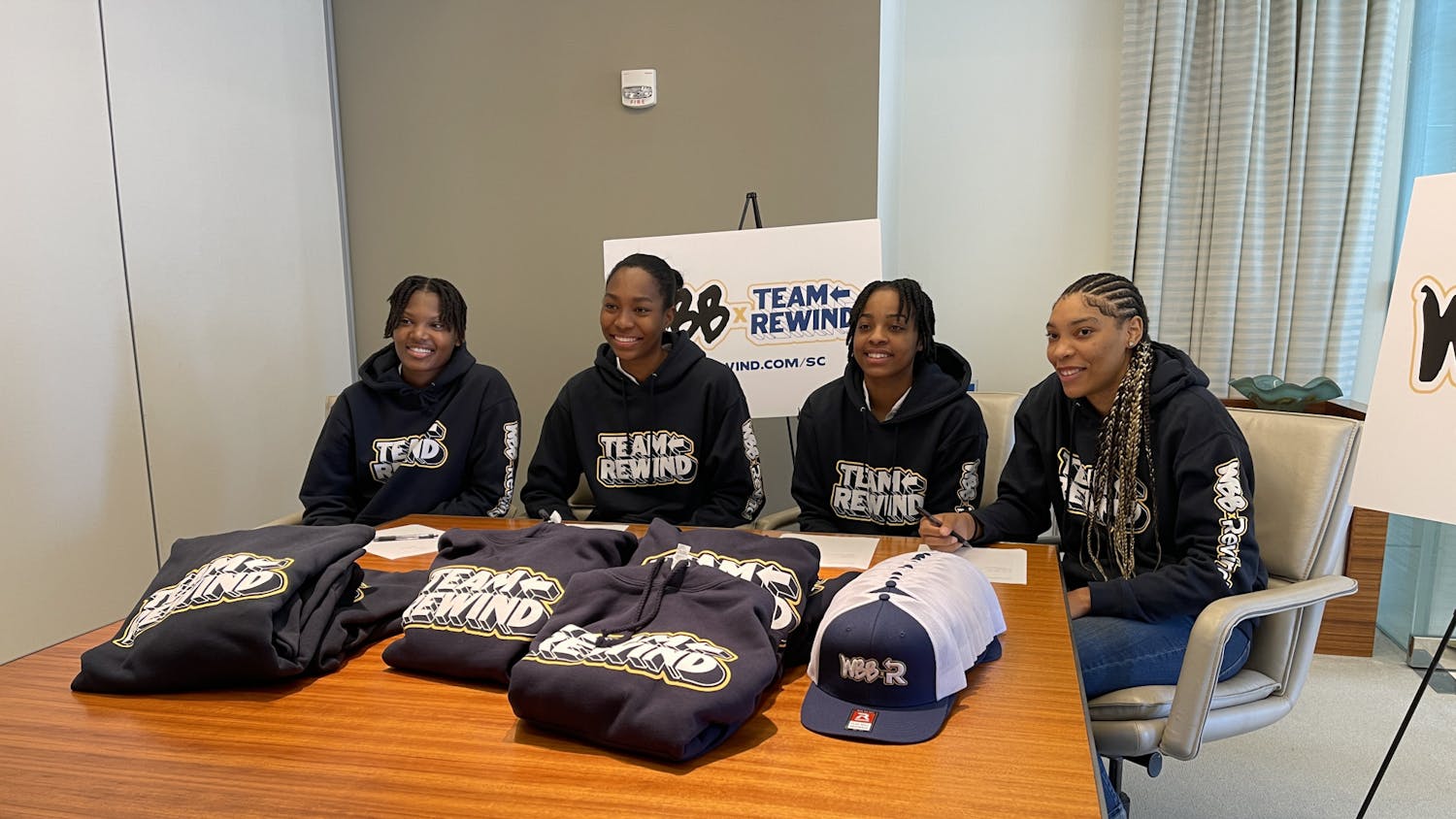 Women’s basketball players (left to right) Sania Feagin, Bree Hall, Kierra Fletcher and Victaria Saxton smile after signing their NIL deals with Rewind on Oct. 6, 2022. South Carolina women’s basketball is partnering with the Rewind program to help fight diabetes in the state of South Carolina.
