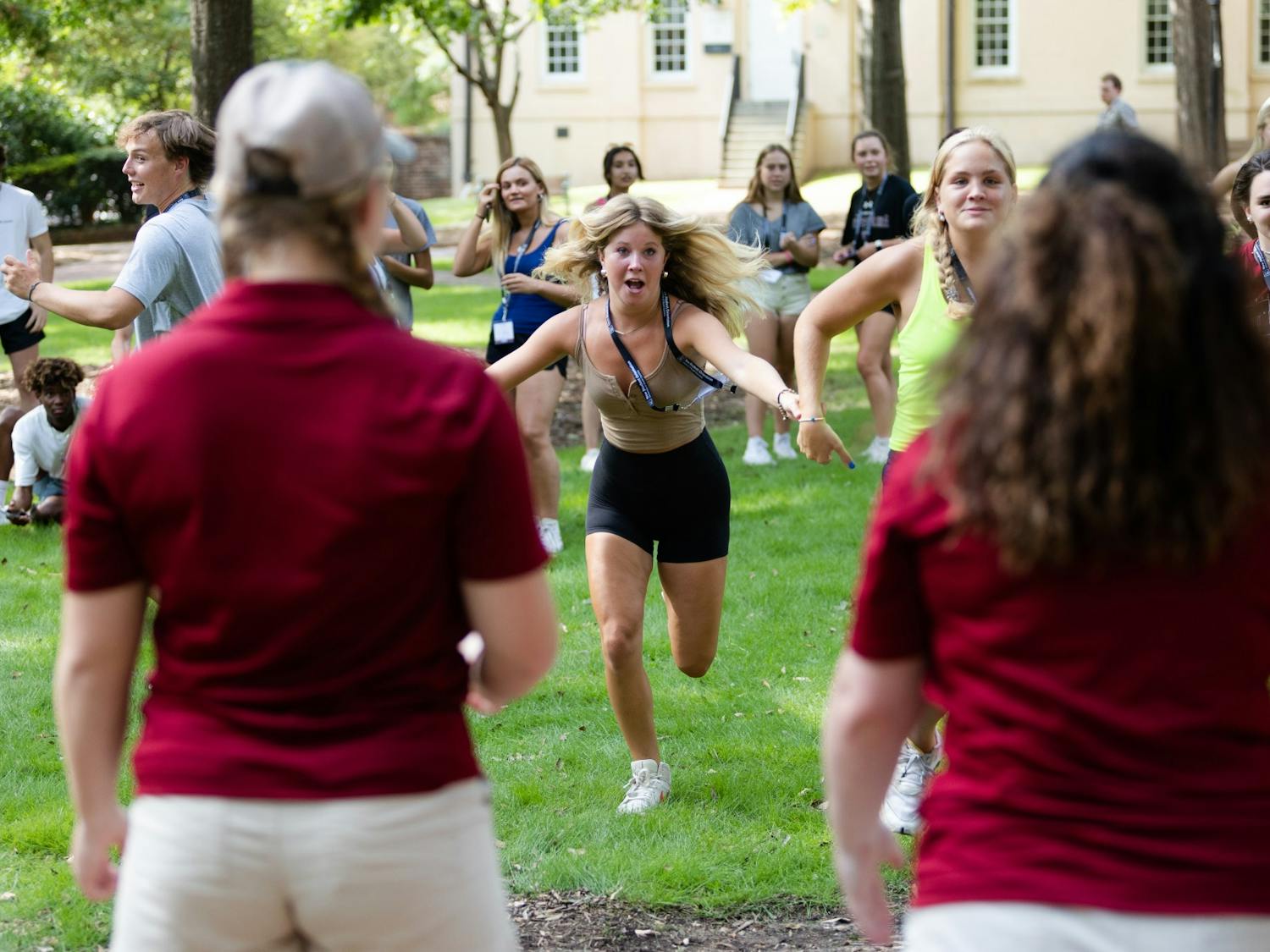 A first-year student drags her friend by the hand, hoping to be the first one to bring her orientation leaders an in-state state student during a game on July 20, 2022. Students listened to presentations, toured campus and played games during orientation sessions held throughout the summer.