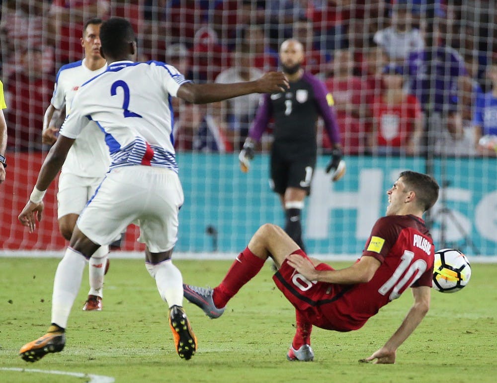 Panama's Michael Murillo (2) throws USA player Christian Pulisic (10) to the ground, resulting in a yellow card for Murillo during World Cup qualifier match at Orlando City Stadium on Friday, Oct. 6, 2017, in Orlando, Fla. The U.S. won, 4-0. (Stephen M. Dowell/Orlando Sentinel/TNS)