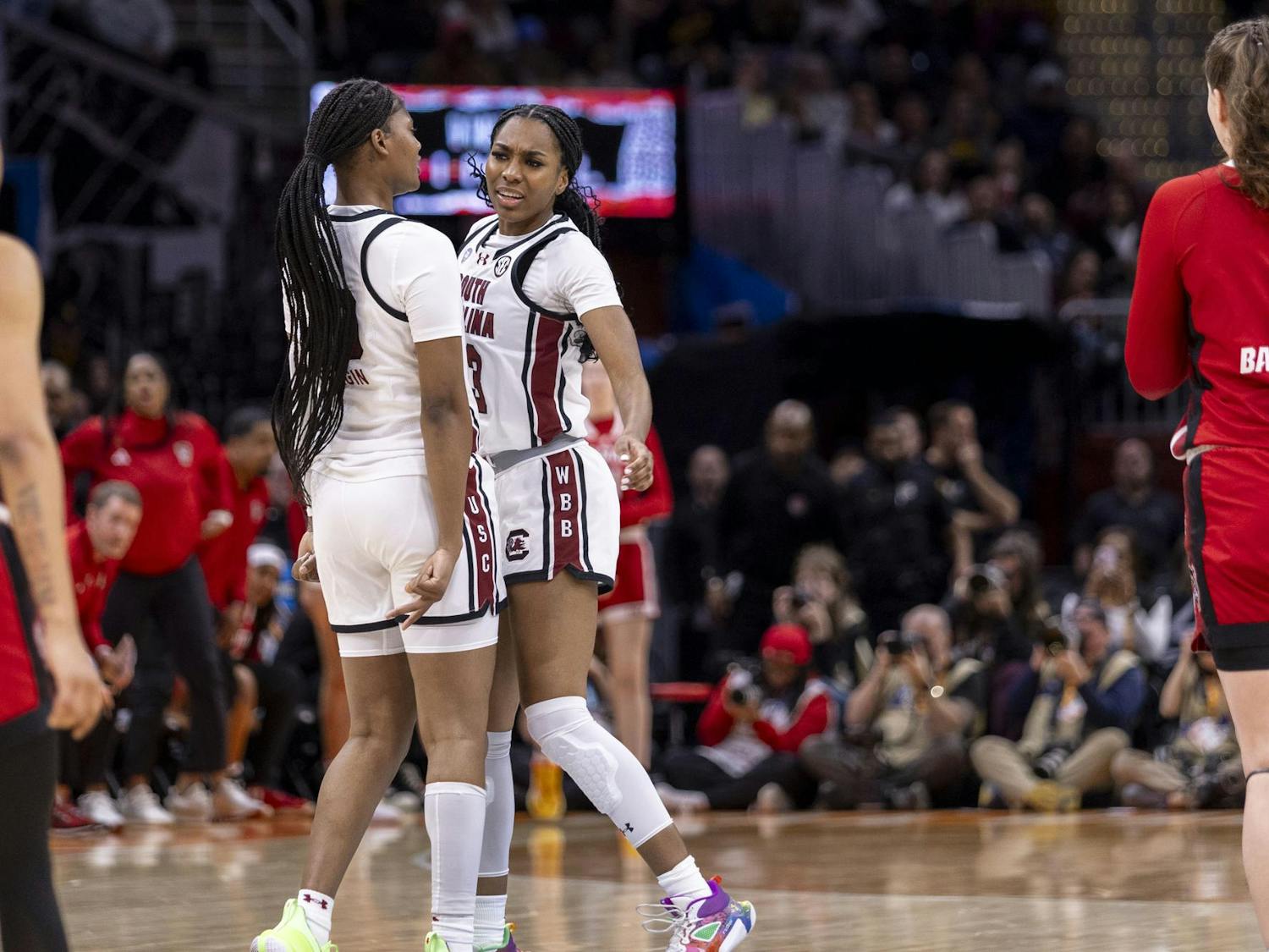 Junior guard Bree Hall (left) and junior forward Sania Feagin (right) chest bump in celebration of Hall scoring a 3-point shot. Hall played 23 minutes for the Gamecocks during its NCAA tournament semi-final victory over the Wolf Pack.
