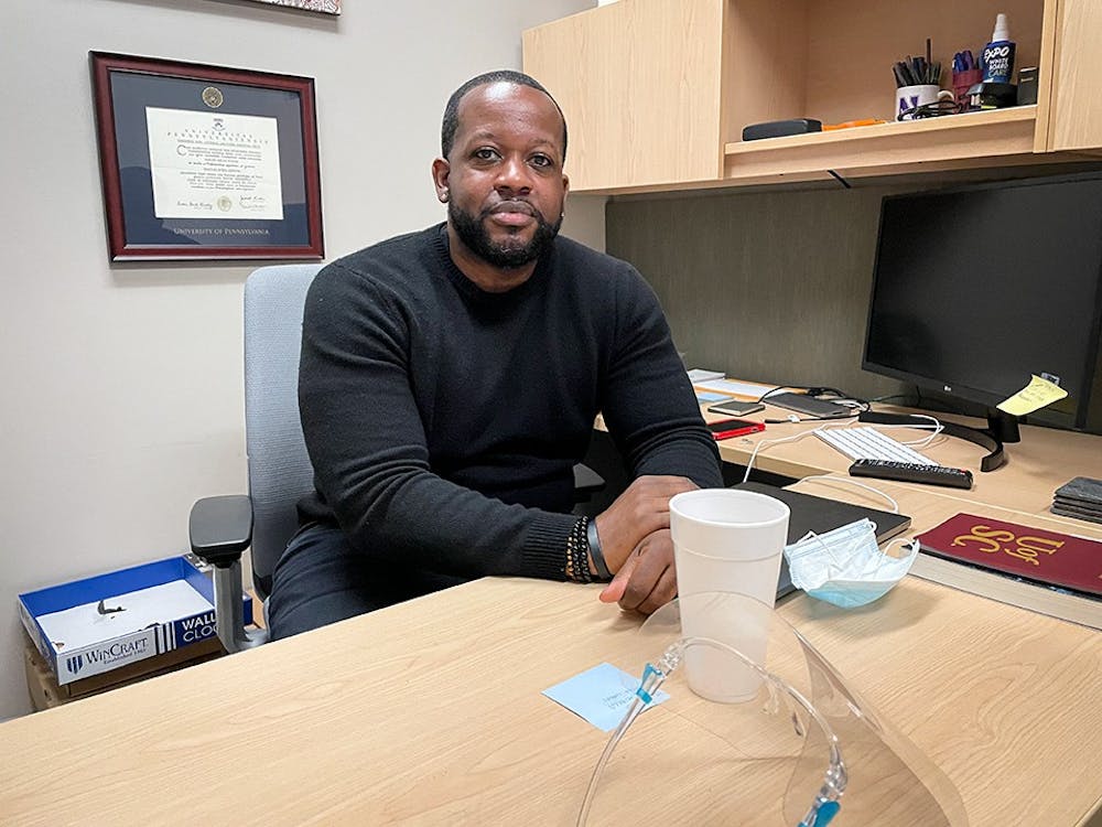 <p>USC professor Jabari Evans sits at his desk in his office in the College of Information and Communications. Dr. Evans teaches media classes in USC's Journalism school.</p>