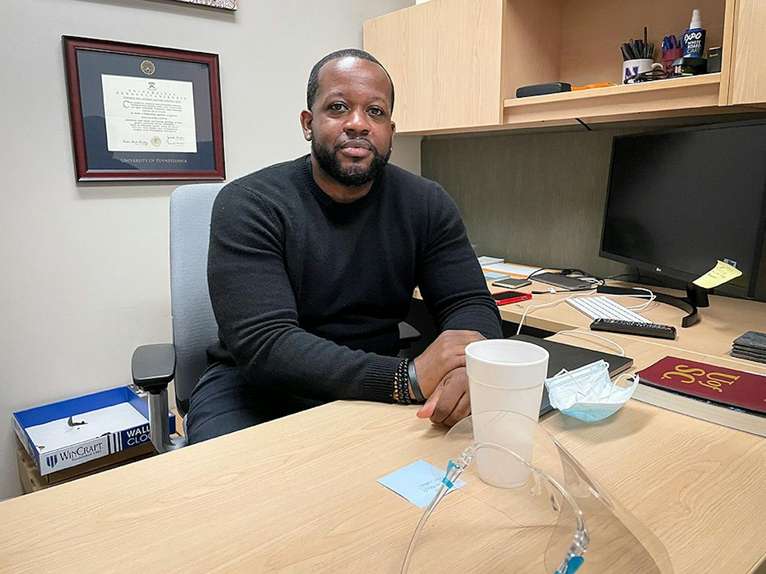 USC professor Jabari Evans sits at his desk in his office in the College of Information and Communications. Dr. Evans teaches media classes in USC's Journalism school.