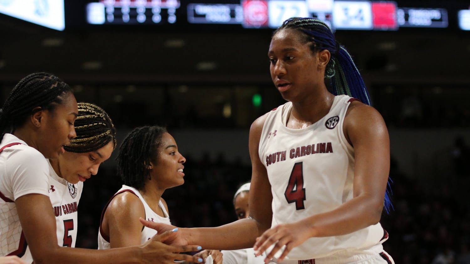 Senior forward Aliyah Boston high-fives her teammates as she makes her way off the court for the night on Jan. 22, 2023. The Gamecocks defeated Arkansas 92-46, and Boston recorded her program-best 73rd career double-double.&nbsp;
