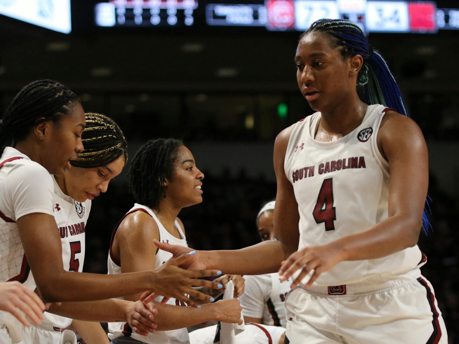 Senior forward Aliyah Boston high-fives her teammates as she makes her way off the court for the night on Jan. 22, 2023. The Gamecocks defeated Arkansas 92-46, and Boston recorded her program-best 73rd career double-double.&nbsp;