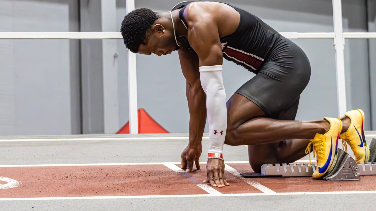 Junior sprinter Jasauna Dennis steps into his blocks as he gets ready to run the men’s 400 meter during the USC Invite indoor track meet on Feb. 21, 2026. He ran his best race of the season, finishing first with a time of 46.07.