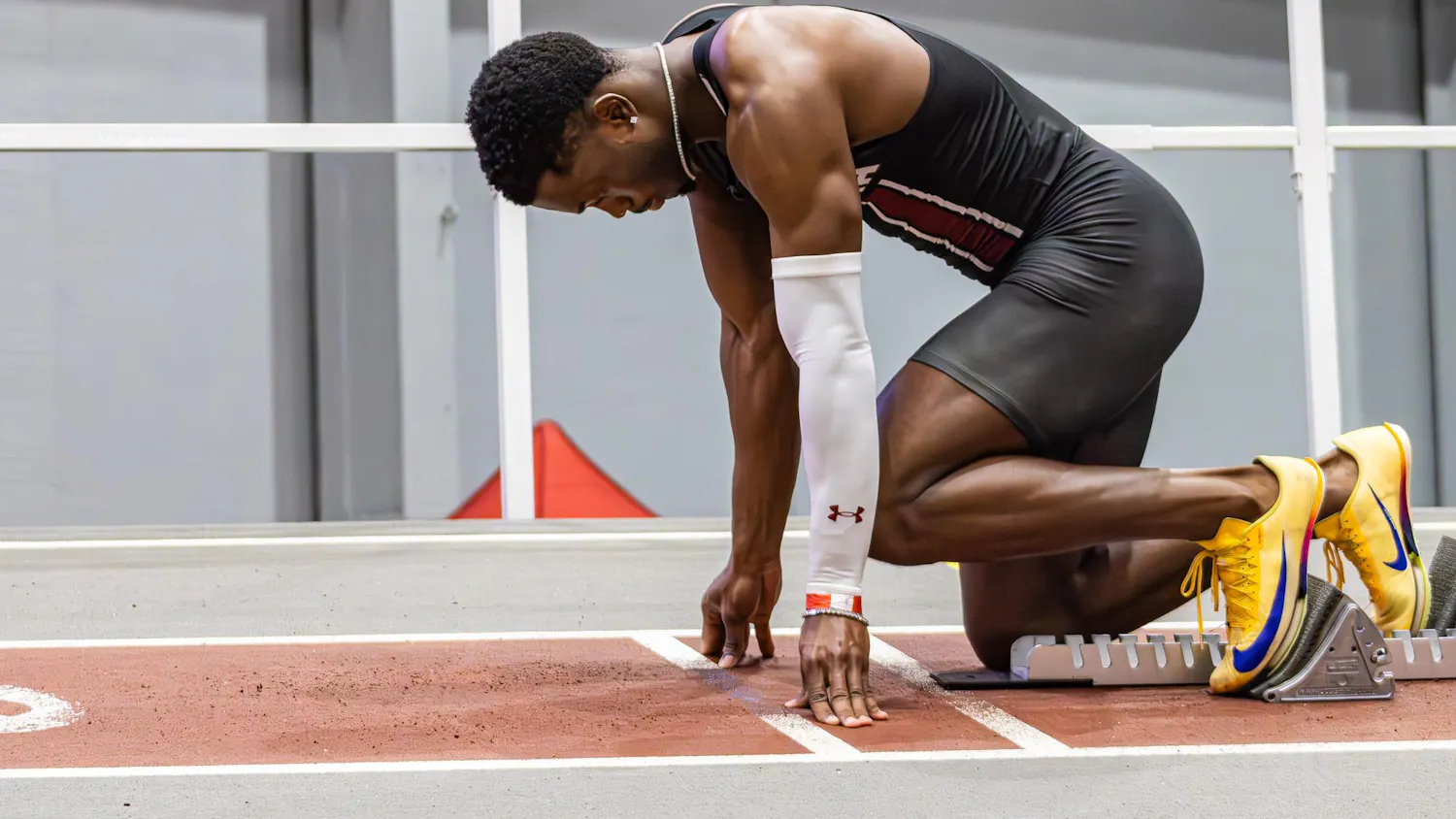 Junior sprinter Jasauna Dennis steps into his blocks as he gets ready to run the men’s 400 meter during the USC Invite indoor track meet on Feb. 21, 2026. He ran his best race of the season, finishing first with a time of 46.07.