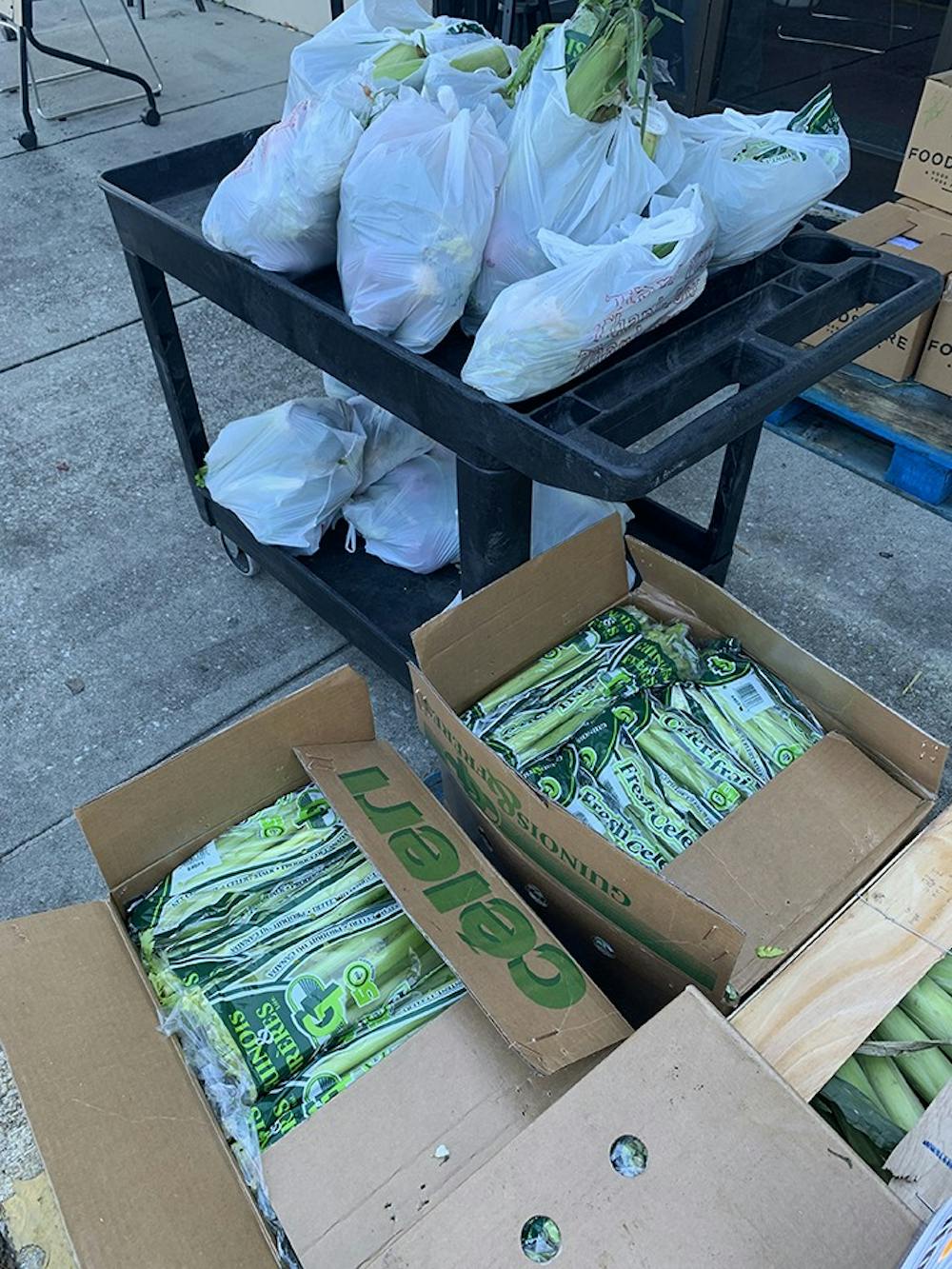 Boxes of celery and corn are brought in to be sold.