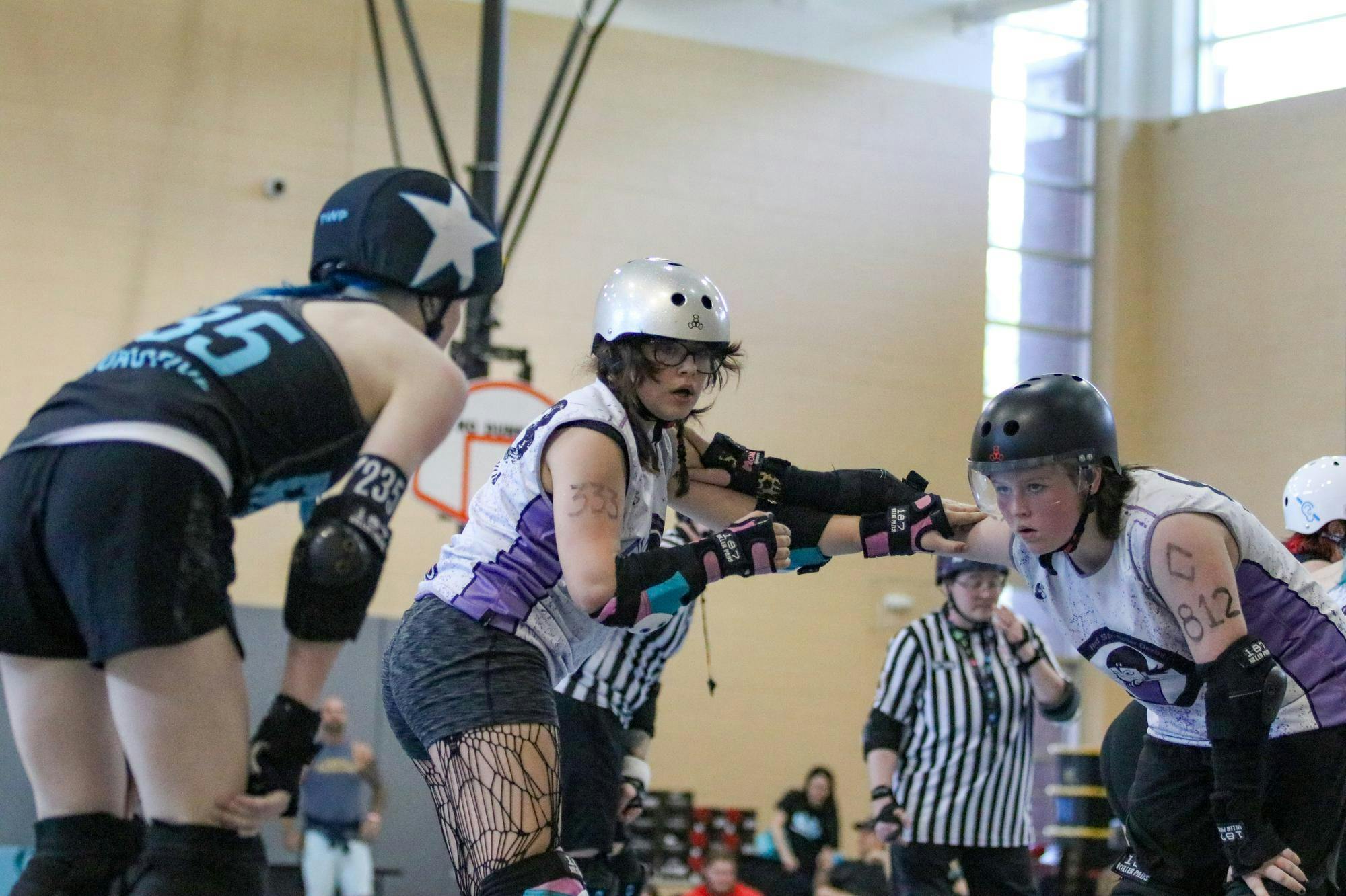 Red Stick Feral skater Annie “Eagle Eye” Everhart blocks the Rockin City Rockstars jammer from passing on March 21, 2026, at St. Andrews Park. A blocker’s goal is to both stop the opposing jammer to pass them and assist their own jammer to pass the opposing blockers. “Really fast juking jammers ... It’s hard to catch them, but it’s fun,” Everhart said.